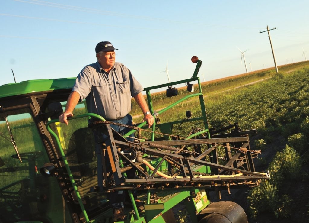 Iowa farmer Denny Friest surveys his fields from his combine.