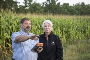 Farmer and advisor in a corn field putting precision agriculture technology to use