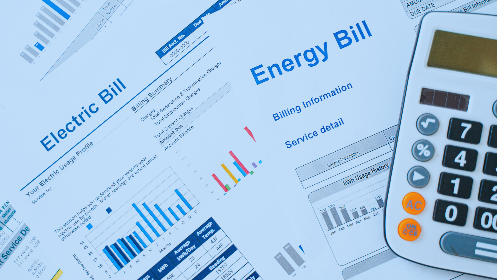 Utility bills spread out on a table.