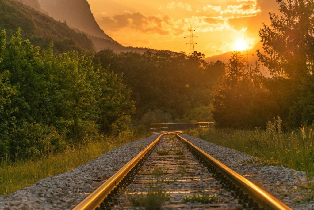 Railroad with electric transmission lines in the background.