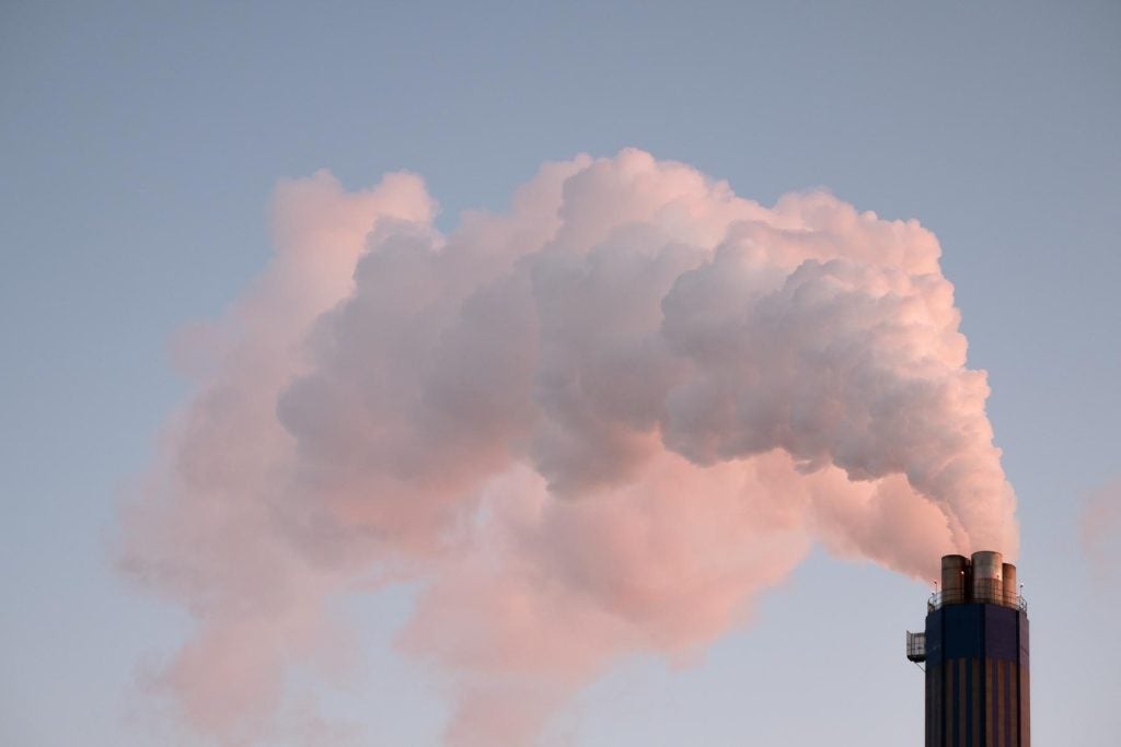 photo of a smokestack at sunset