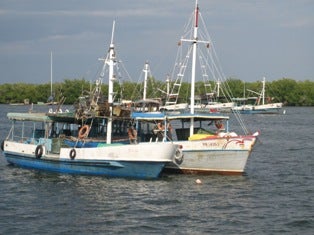 Two lobster boats in Coloma, one of Cuba’s most important fishing ports.”