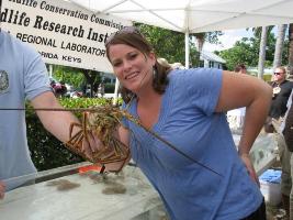 Kate Culzoni with a spiny lobster at the Florida Keys Seafood Festival