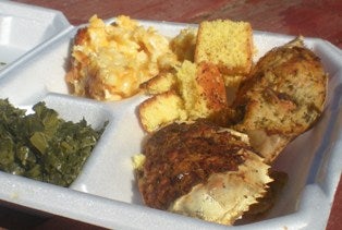 Gullah/Geechee Seafood Festival - Container of collard greens, macaroni and cheese, cornbread and stuffed crab and other seafood.