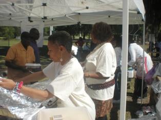 Gullah/Geechee Fishing Association Seafood Festival - People preparing food under a white tent
