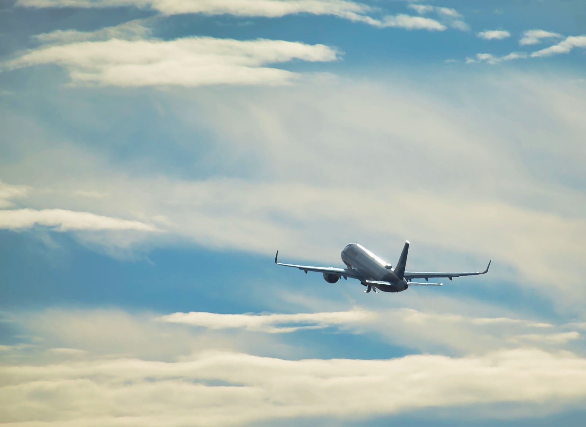 Airplane flying through blue sky