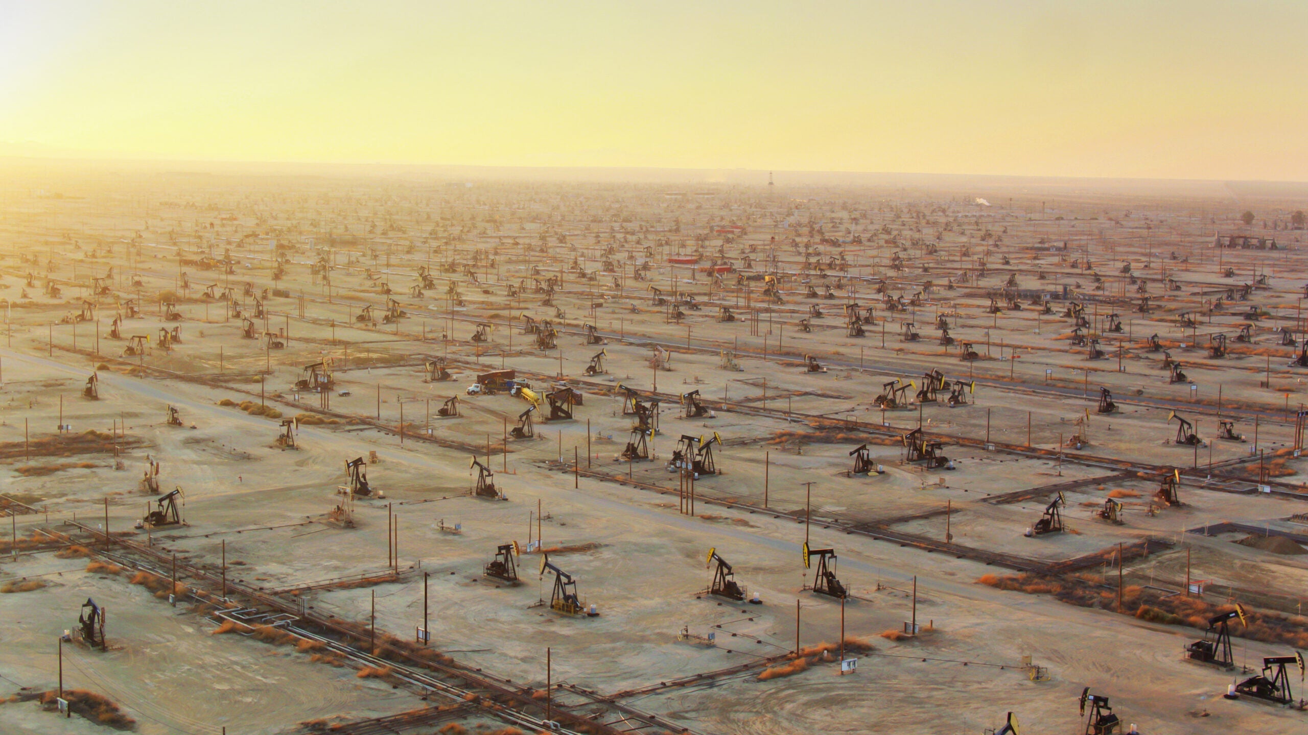 Drone shot of oil pump jacks in Missouri Triangle, Kern County, California. This intensive drilling operation is part of the South Belridge Oil Field in the San Joaquin Valley.