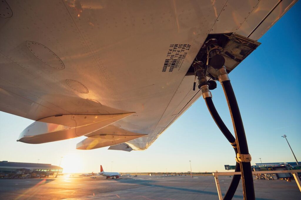 Amazing sunset at the airport. Refueling of the airplane before flight