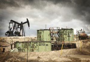 Pump jacks and storage tanks at oil field