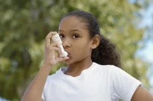 person with asthma using an inhaler