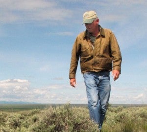 A Montana rancher walks across the sagebrush habitat on his property -- habitat vital for survival of greater sage-grouse