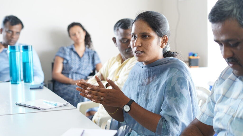 Image of Shanthra P as she talks to others in a round table event