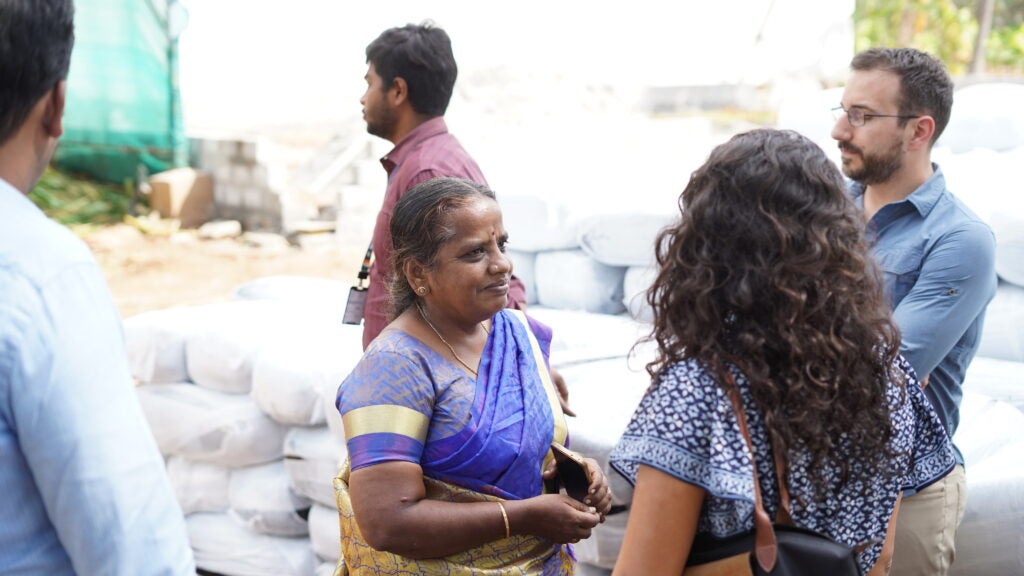 two Indian women talking about business in a market 