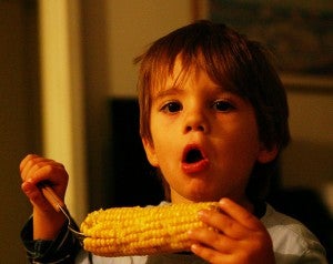 child eating corn