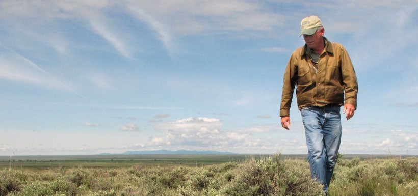 A rancher near Malta, Montana walks across the sagebrush landscape - quality habitat for greater sage-grouse