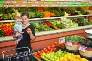 Mother and child picking up produce