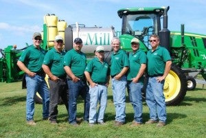 Farmers in front of a tractor 