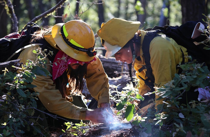 Esak Ordonez and Chanel Keller opened the training exercises with an offering flame to the land. (Shmuel Thaler)  - Prescribed burn fire training event held at Mt. Madonna Center in the Santa Cruz Mountains outside of Watsonville, CA