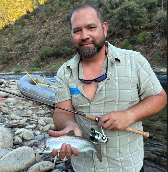 Austin Stevenot holds a rainbow trout.