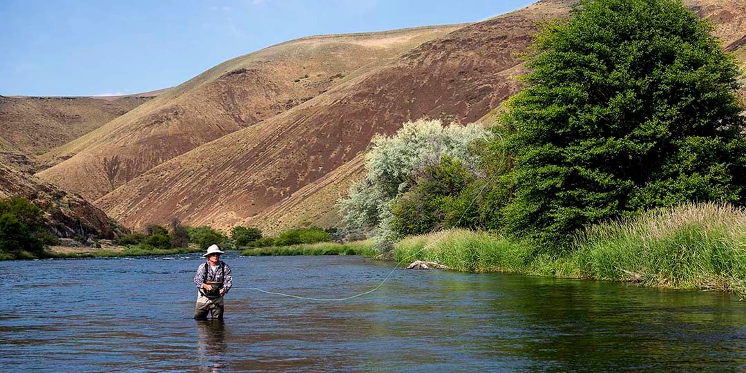 Man flyfishing on Deschutes River.