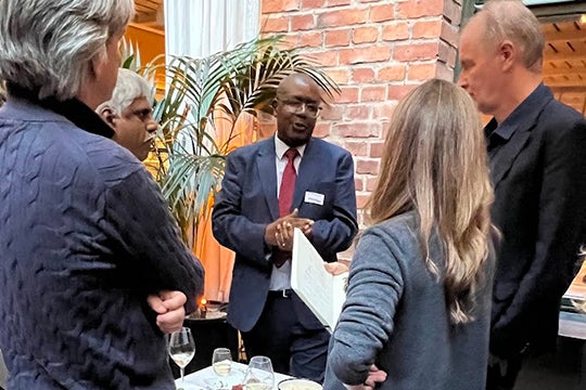 Four people gather around a table to share ideas