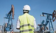 worker with oil derricks