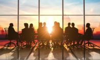 People in a conference room at sunset